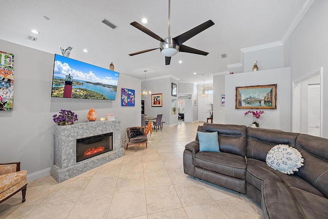 living room with ornamental molding, light tile patterned floors, and ceiling fan