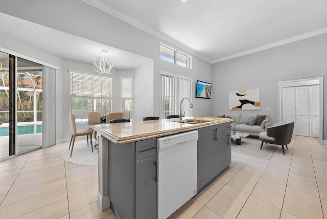 kitchen featuring dishwasher, a textured ceiling, light tile patterned floors, and a sink