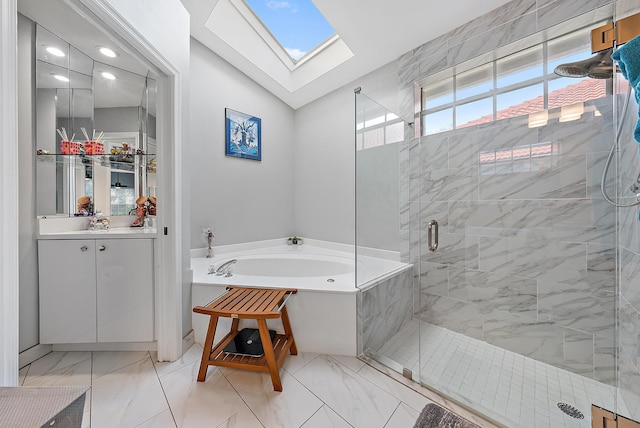 full bathroom with a shower stall, vaulted ceiling with skylight, a bath, marble finish floor, and vanity