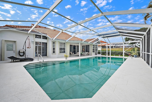 view of swimming pool featuring a patio area, a fenced in pool, and glass enclosure