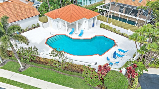 community pool featuring a fenced backyard and a patio area