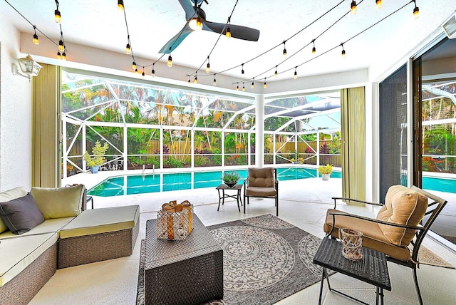 view of swimming pool with a lanai, outdoor lounge area, ceiling fan, and a patio area