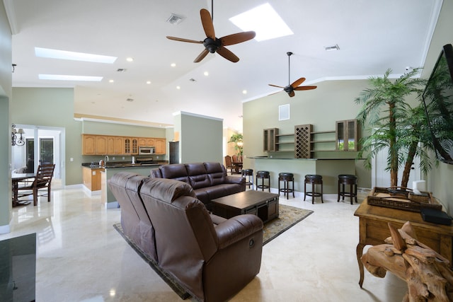 living room with crown molding, a skylight, and high vaulted ceiling