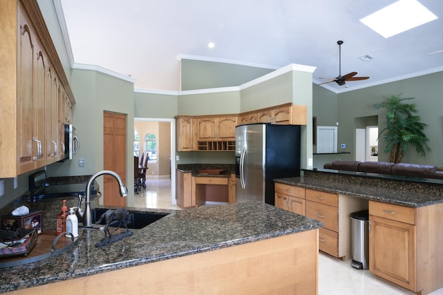 kitchen featuring appliances with stainless steel finishes, kitchen peninsula, sink, and dark stone counters