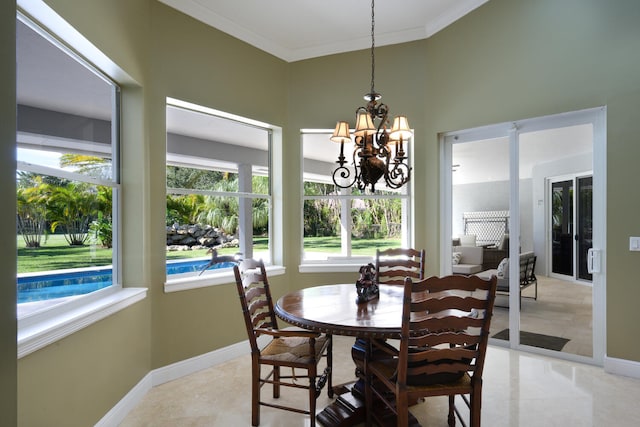 dining space with crown molding and a chandelier