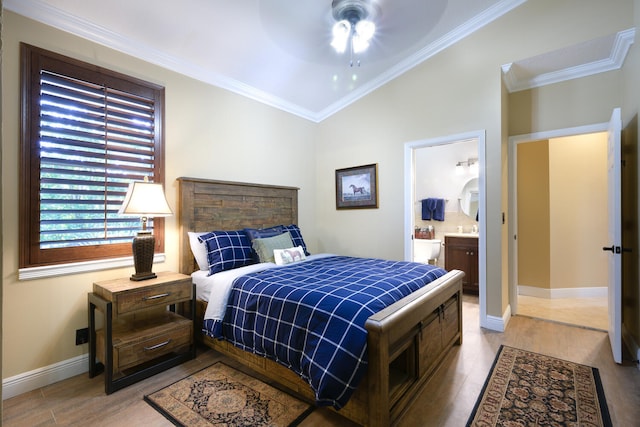 bedroom with connected bathroom, light hardwood / wood-style flooring, ornamental molding, and ceiling fan