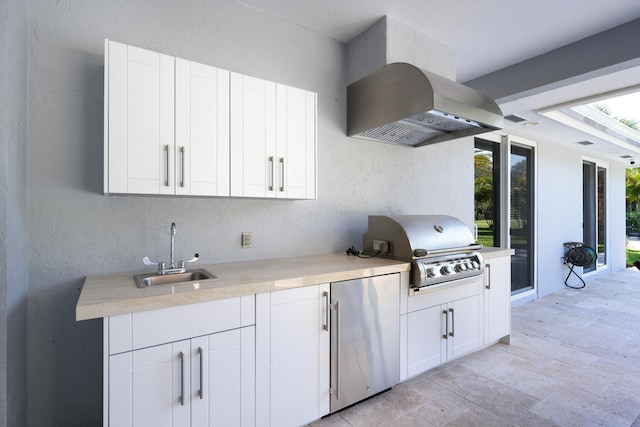 view of patio / terrace featuring a grill, exterior kitchen, and sink