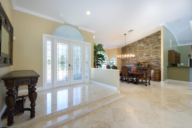 entryway with crown molding, a notable chandelier, high vaulted ceiling, and french doors