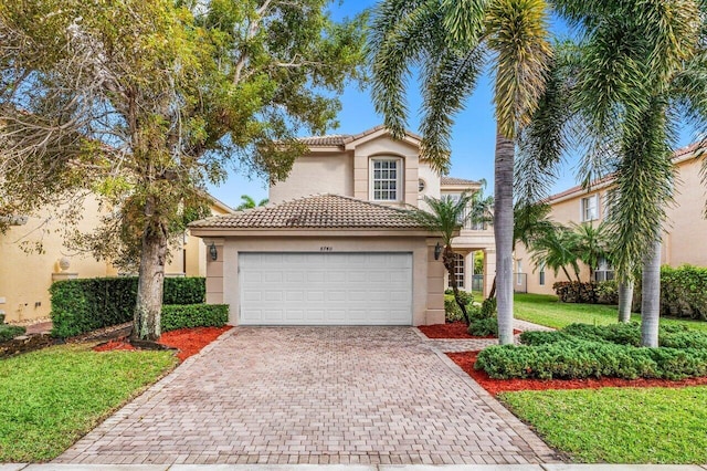 mediterranean / spanish-style house with a garage and a front lawn