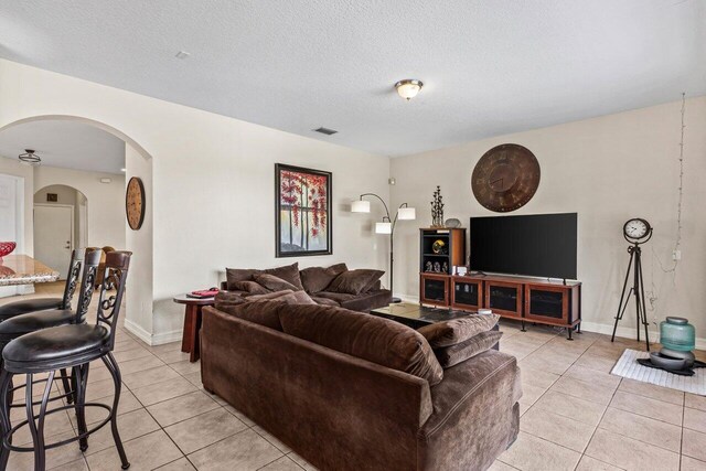 tiled living room with a textured ceiling