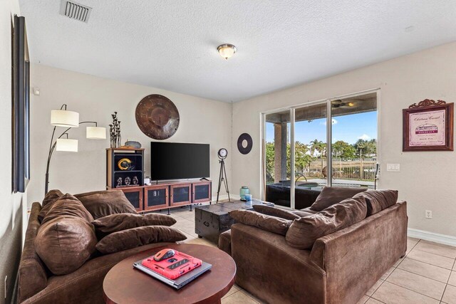 living room featuring light tile patterned floors and a textured ceiling