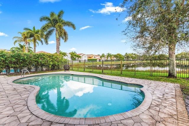 view of pool featuring a water view and a patio area