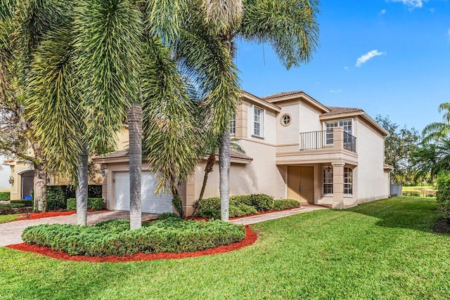 mediterranean / spanish-style house with a garage, a front yard, and a balcony