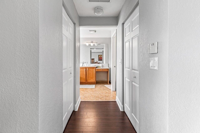 hall with dark hardwood / wood-style floors and sink