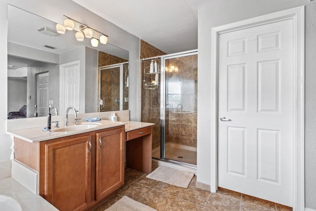 bathroom with vanity and a shower with shower door