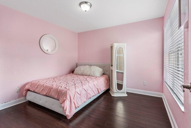 spare room with dark wood-type flooring and a textured ceiling