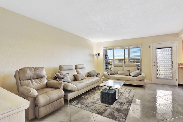 tiled living room featuring a textured ceiling