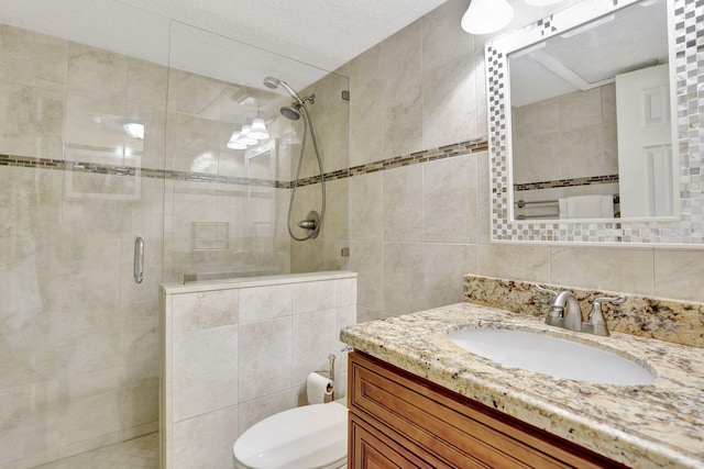 bathroom with tile walls, backsplash, an enclosed shower, vanity, and toilet