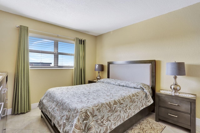 bedroom with light tile patterned floors and a textured ceiling