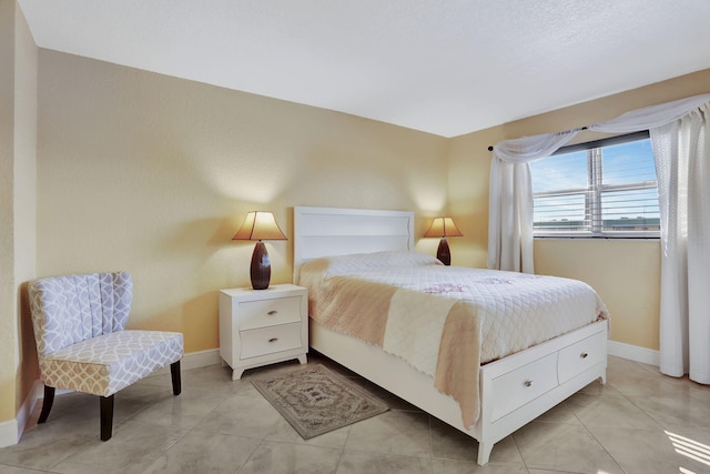 bedroom with light tile patterned floors