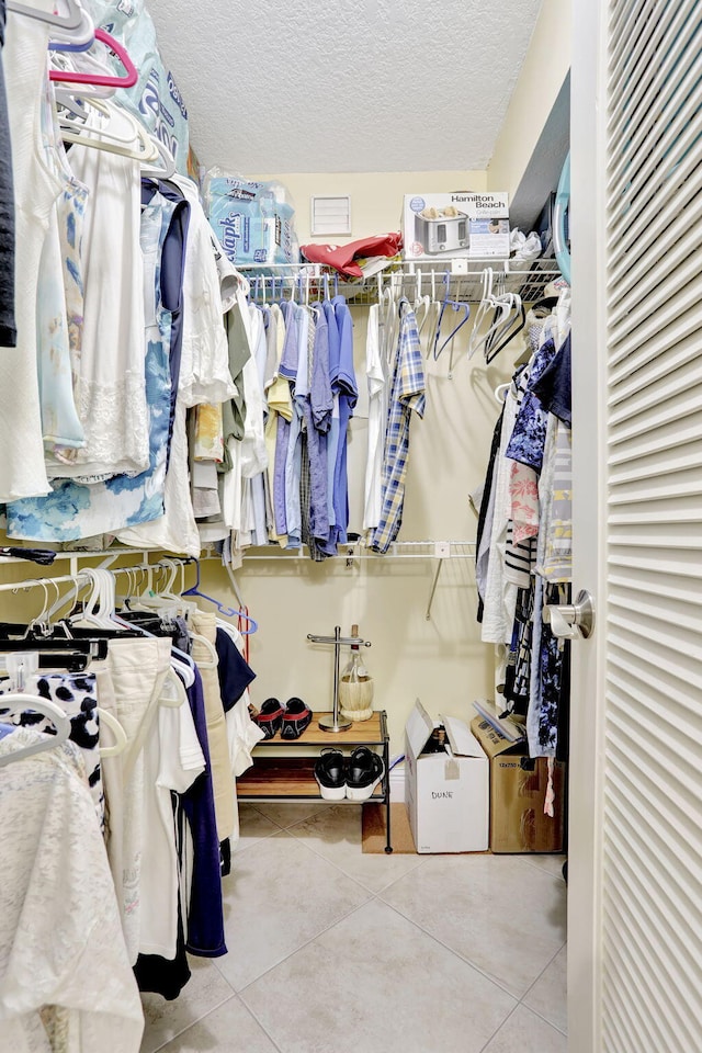 walk in closet with tile patterned floors