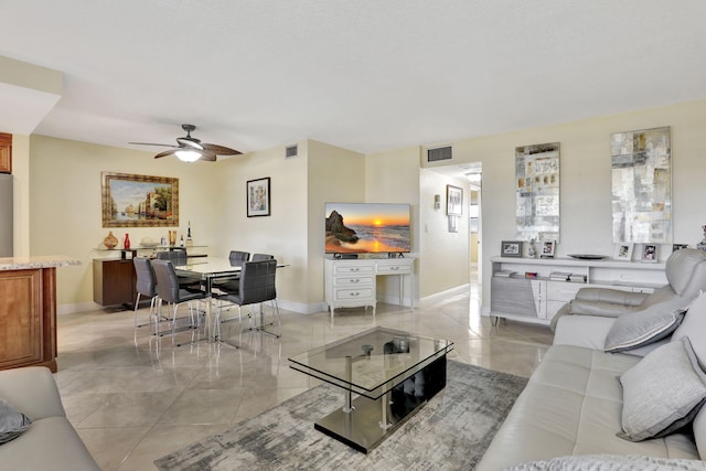 living room with light tile patterned flooring and ceiling fan