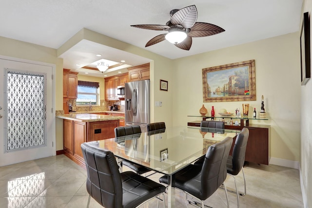 dining area with light tile patterned flooring and ceiling fan