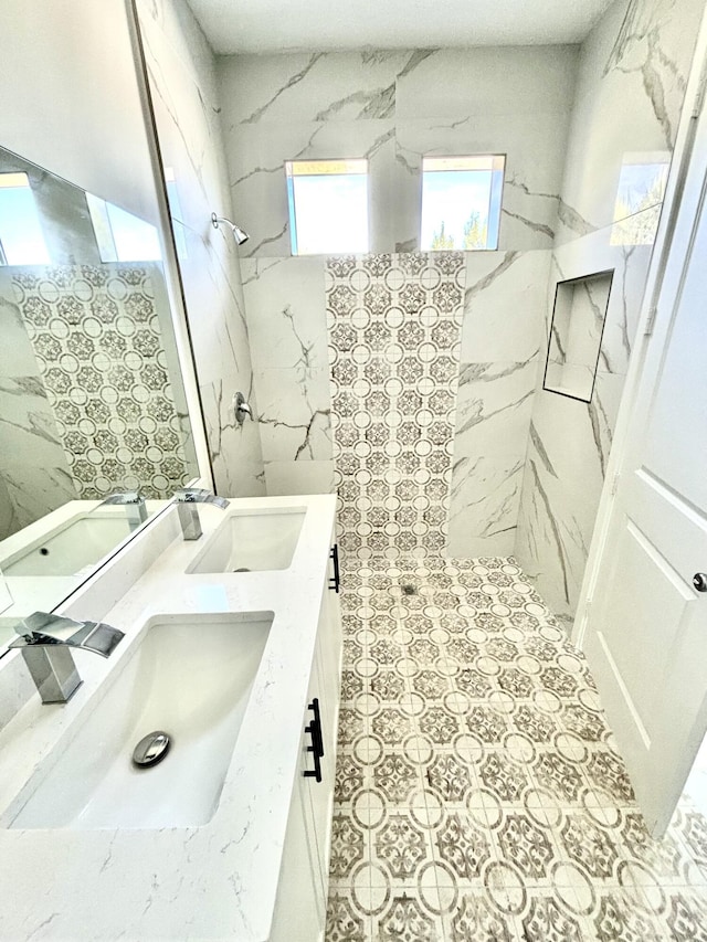 bathroom featuring vanity and tiled shower