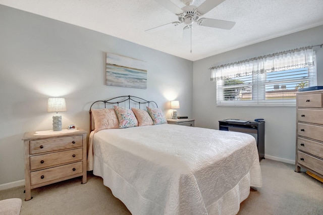 bedroom featuring ceiling fan, light colored carpet, and a textured ceiling