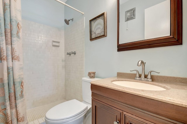 bathroom with vanity, curtained shower, and toilet