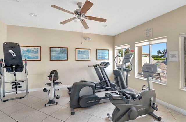 exercise room with light tile patterned floors and ceiling fan