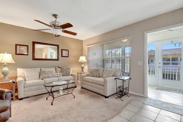 living room featuring light colored carpet and ceiling fan