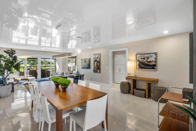 dining area featuring a towering ceiling