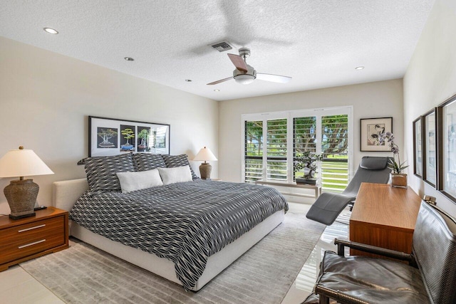 bedroom featuring a textured ceiling and ceiling fan