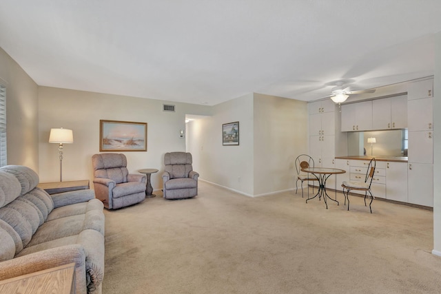 carpeted living room with ceiling fan