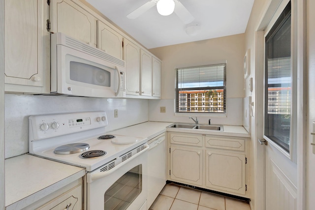 kitchen with sink, white appliances, light tile patterned floors, and ceiling fan