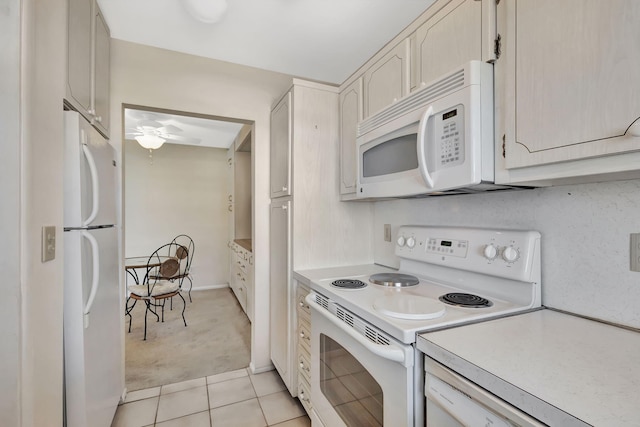 kitchen featuring white appliances and light tile patterned floors