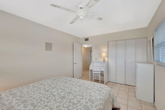 tiled bedroom featuring a closet and ceiling fan