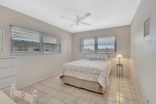 bedroom with ceiling fan and light tile patterned floors