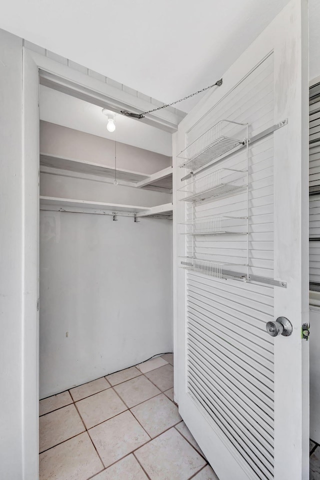 spacious closet featuring light tile patterned floors