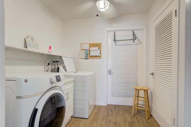 clothes washing area with light hardwood / wood-style flooring, washing machine and dryer, cabinets, and ceiling fan