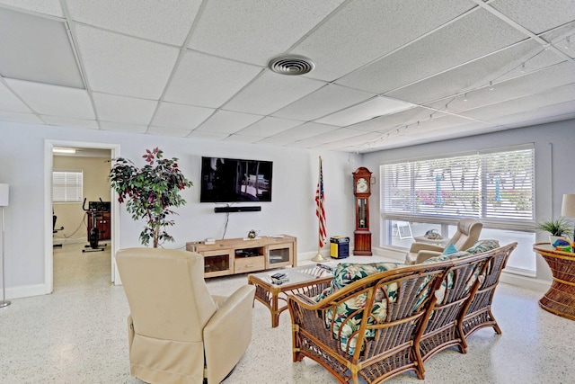 living room featuring a drop ceiling