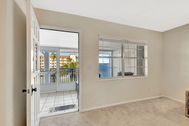 doorway to outside featuring light colored carpet