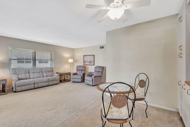 carpeted living room featuring ceiling fan