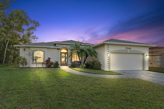 single story home with a yard and a garage