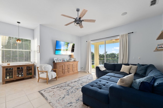 tiled living room with ceiling fan