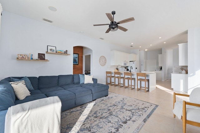 living room featuring light tile patterned flooring and ceiling fan