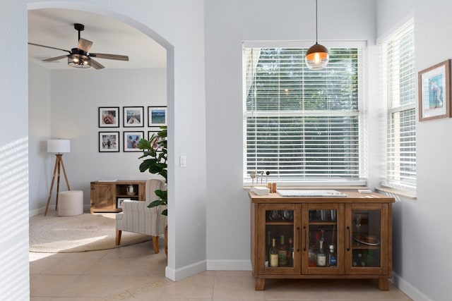 interior space featuring hanging light fixtures, ceiling fan, and light tile patterned flooring