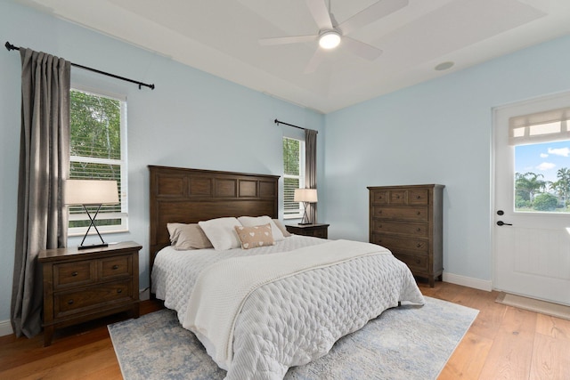 bedroom with ceiling fan and light hardwood / wood-style flooring