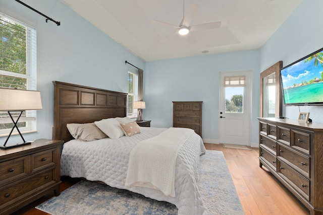 bedroom with multiple windows, ceiling fan, and light hardwood / wood-style flooring